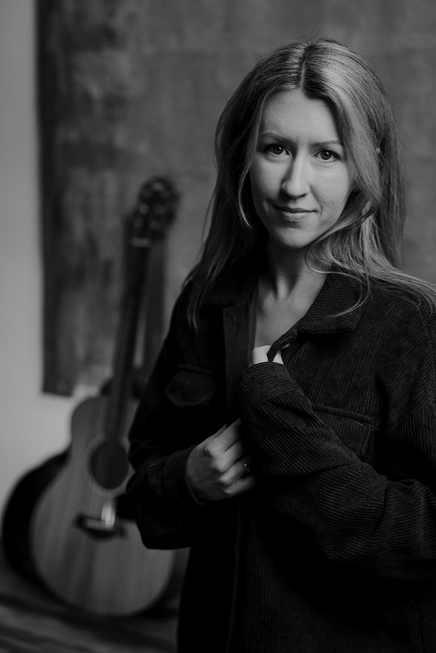 Brí sitting down singing into a microphone